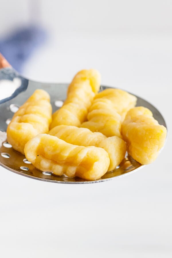 cooked dumplings on a metal utensil