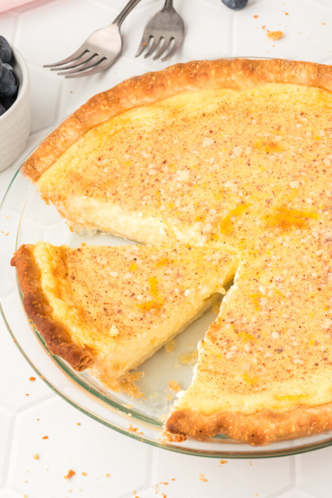 whole old-fashioned custard pie with a slice cut