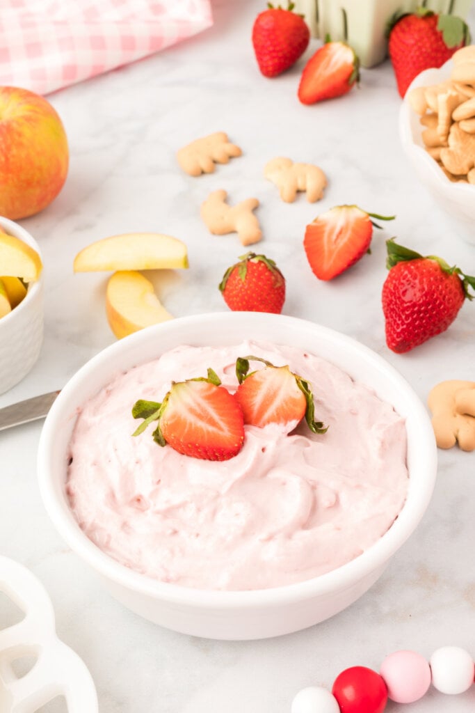 strawberry cream cheese fruit dip garnished with cut strawberry