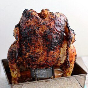 baja citrus chicken on beer can stand in metal tray