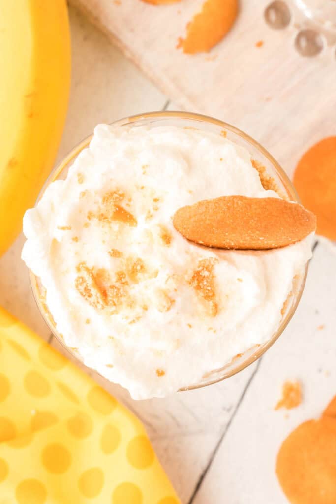 finished banana pudding parfait topped with whipped cream, cookie crumbs, and a Nilla wafer