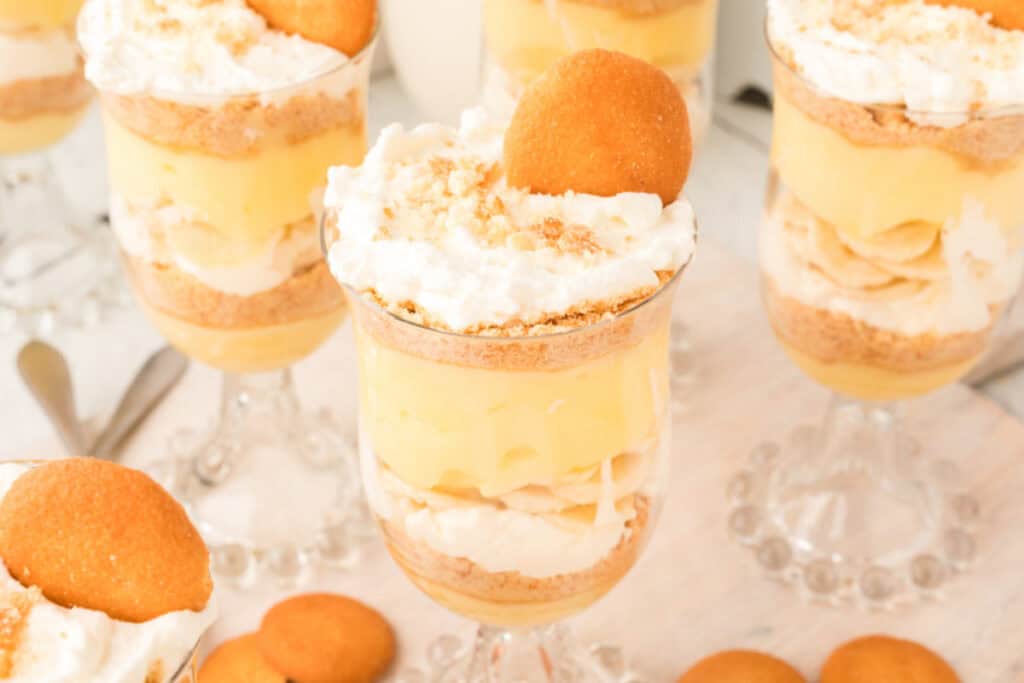 close-up of banana pudding parfait showing layers of pudding, bananas, whipped cream, and cookie crumbs