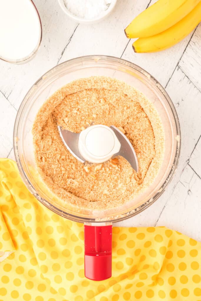 crushed Nilla wafers in a food processor forming fine crumbs for banana pudding parfait