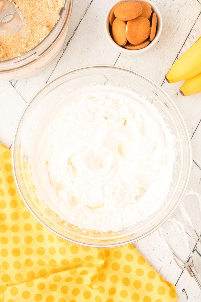 whipped cream beaten to soft peaks in a glass bowl for banana pudding parfait