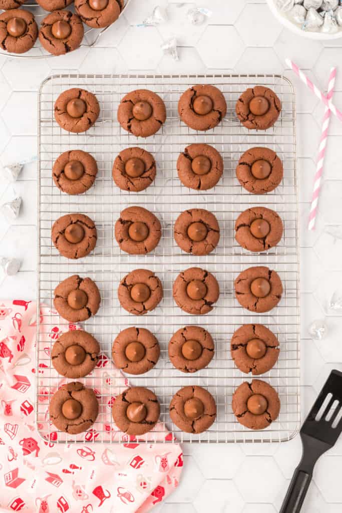 Chocolate Blossoms cooling on a wire rack with Hershey's Kisses centers