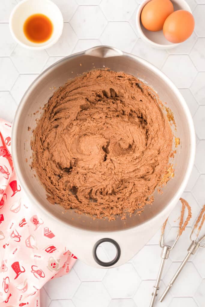 Butter, Nutella, and sugars creamed together in a mixing bowl for Chocolate Blossoms cookie dough