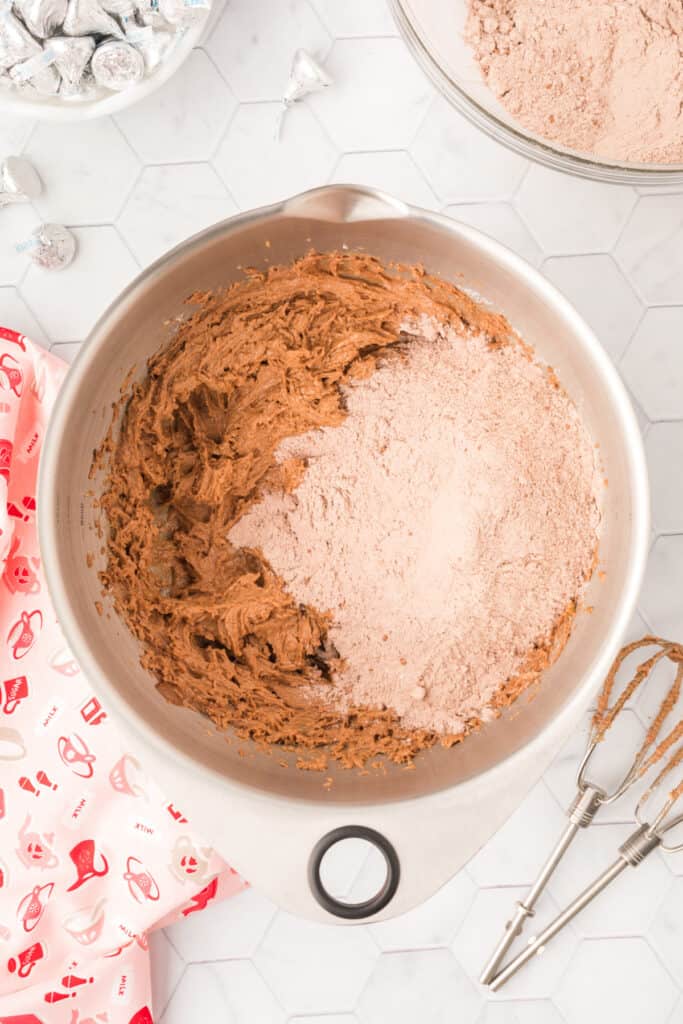 Dry ingredients being added to the chocolate cookie mixture for Chocolate Blossoms