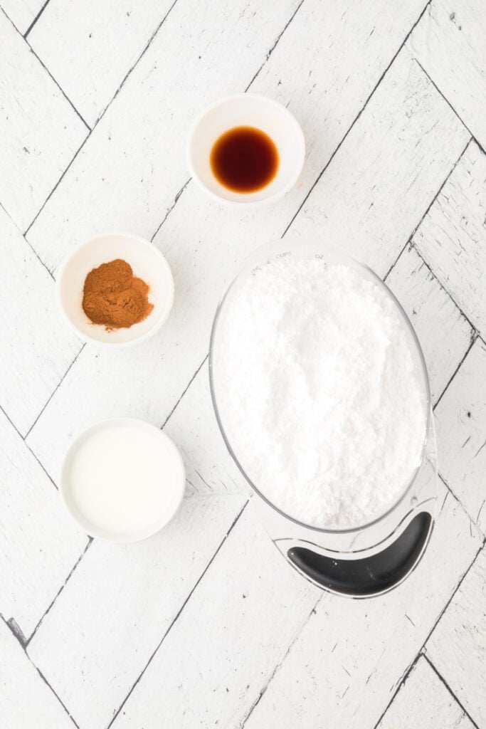 Ingredients for the cinnamon glaze, including powdered sugar and cinnamon.