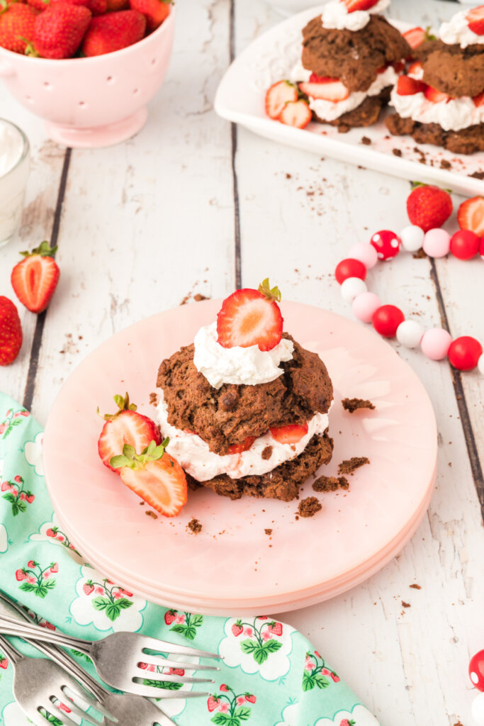 looking down onto a pink plate with chocolate strawberry shortcake