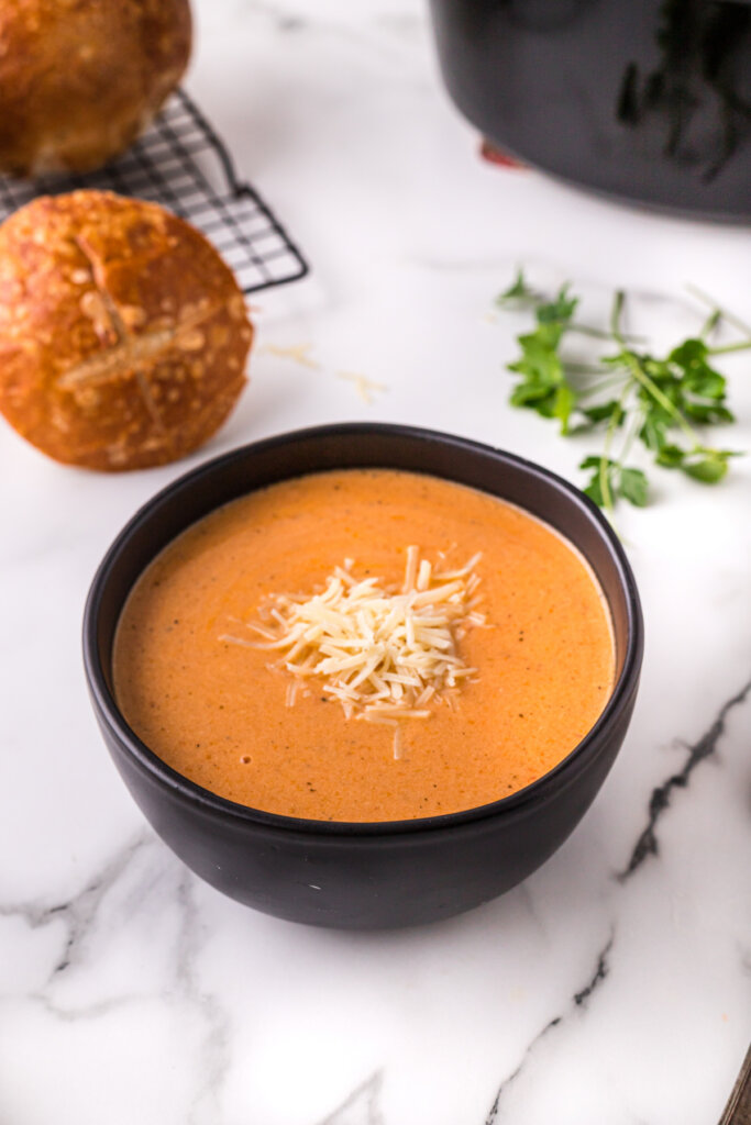 black bowl filled with creamy tomato soup