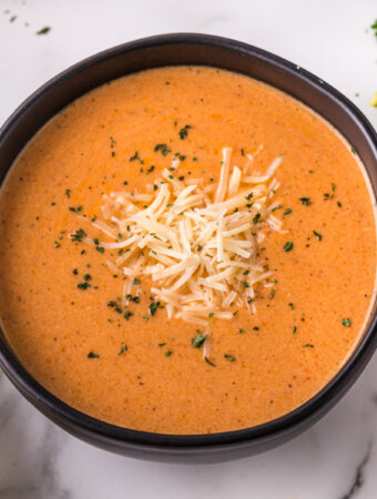 creamy tomato soup in black bowl