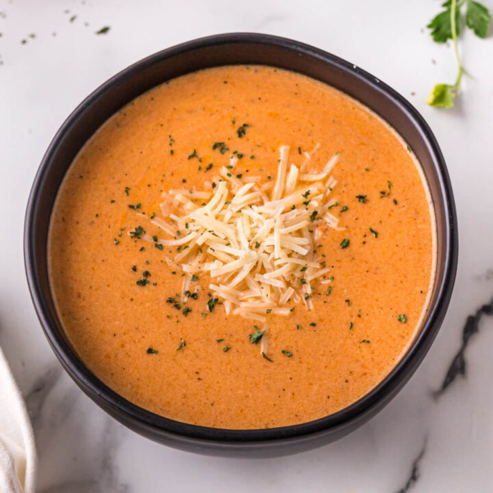 creamy tomato soup in black bowl