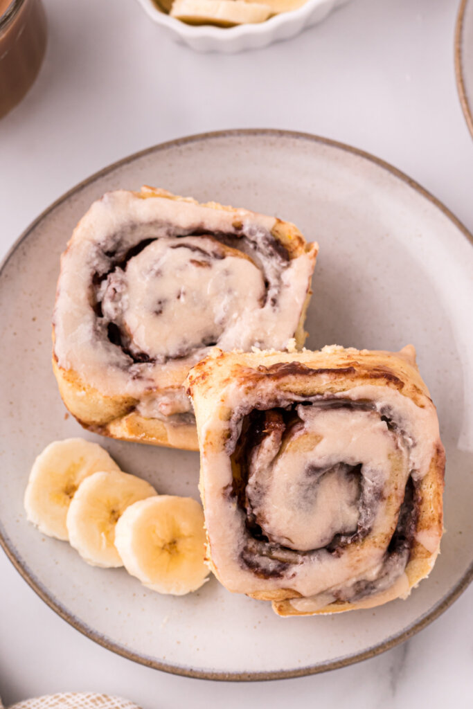 two nutella banana cinnamon rolls on plate