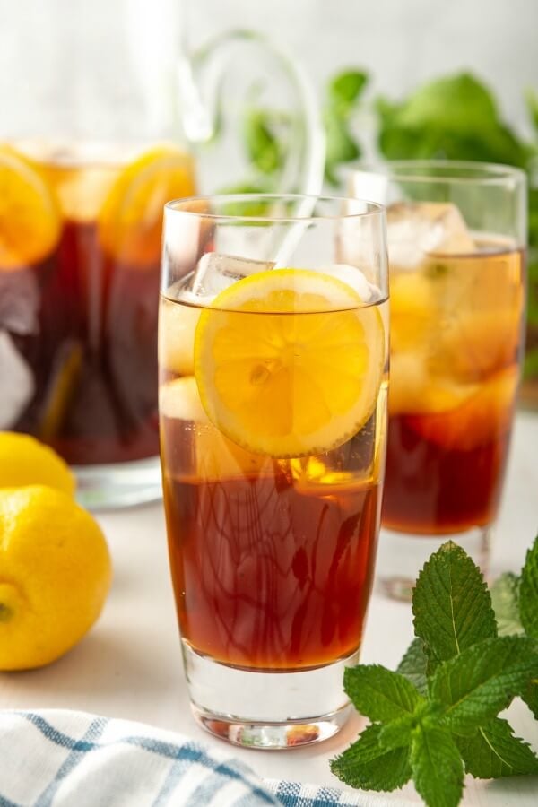 cold glass of sweet iced tea with lemon