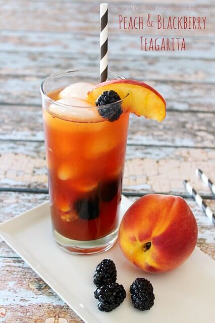 Jose Cuervo Iced Teagarita consists of the classic limeA Peach and Blackberry Teagarita in a glass with a peach next to the glass.