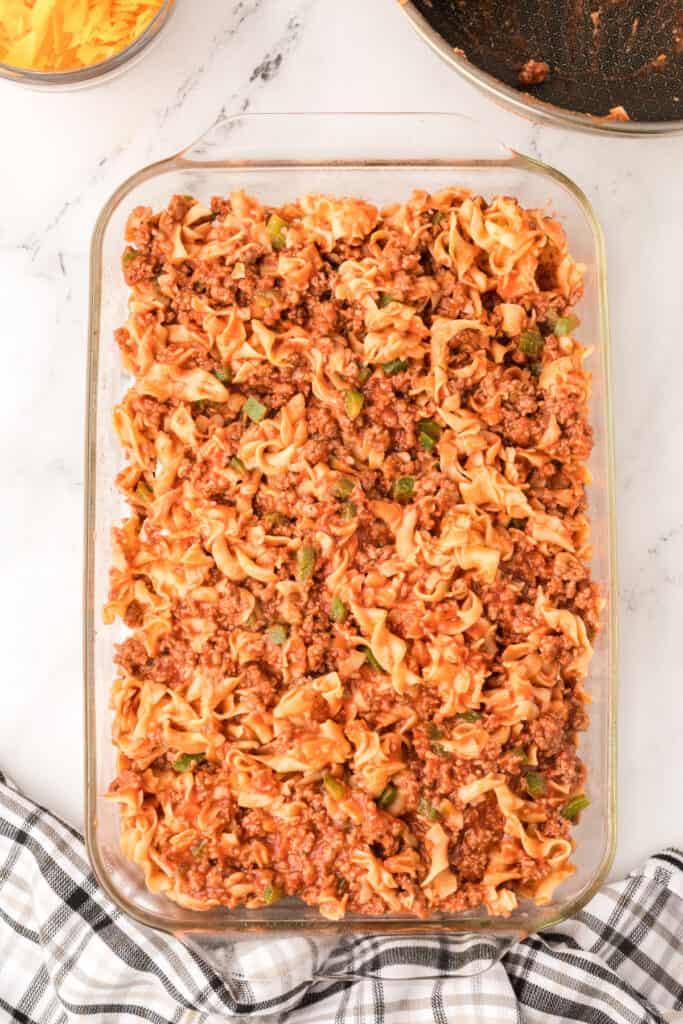 second layer of beef and noodle mixture added on top in baking dish
