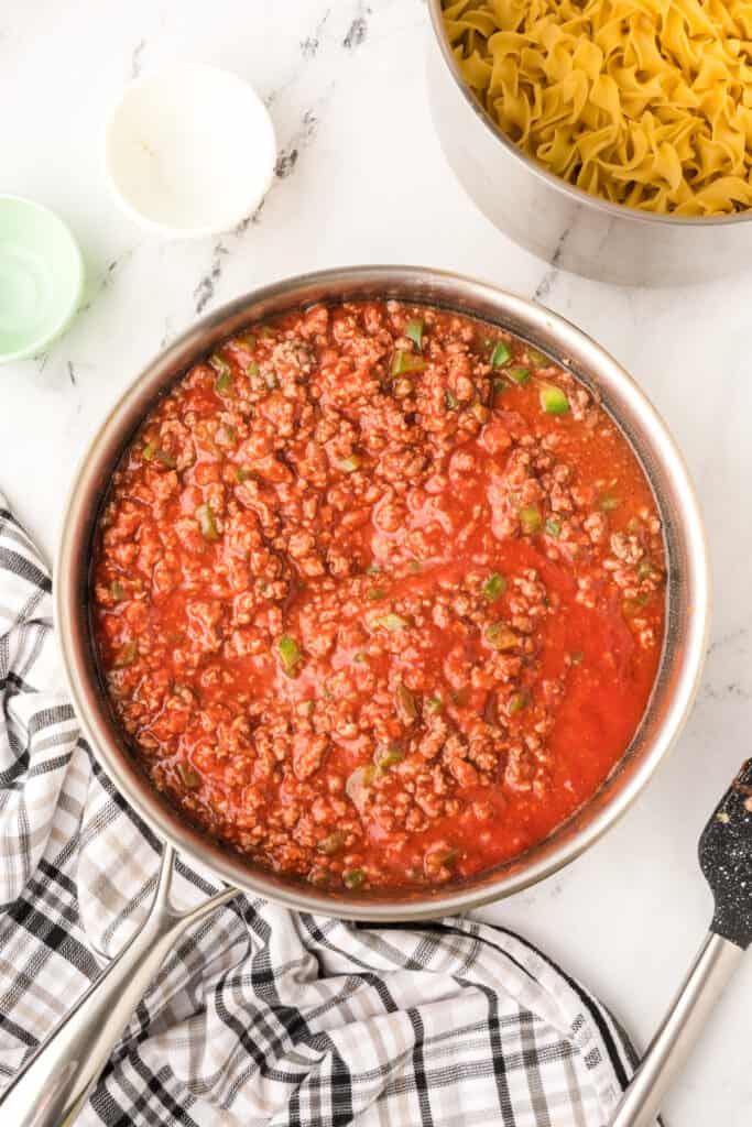beef and tomato sauce mixture fully combined and simmering in skillet