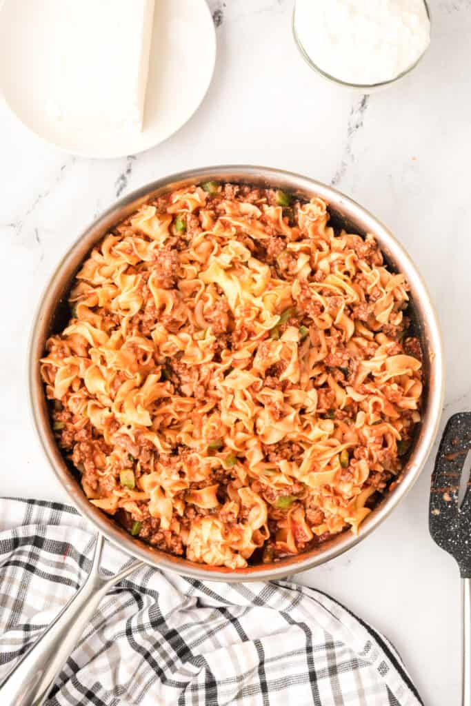 beef and noodle mixture stirred together in skillet