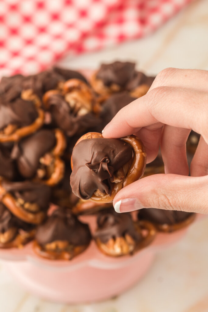 hand holding chocolate turtle candy