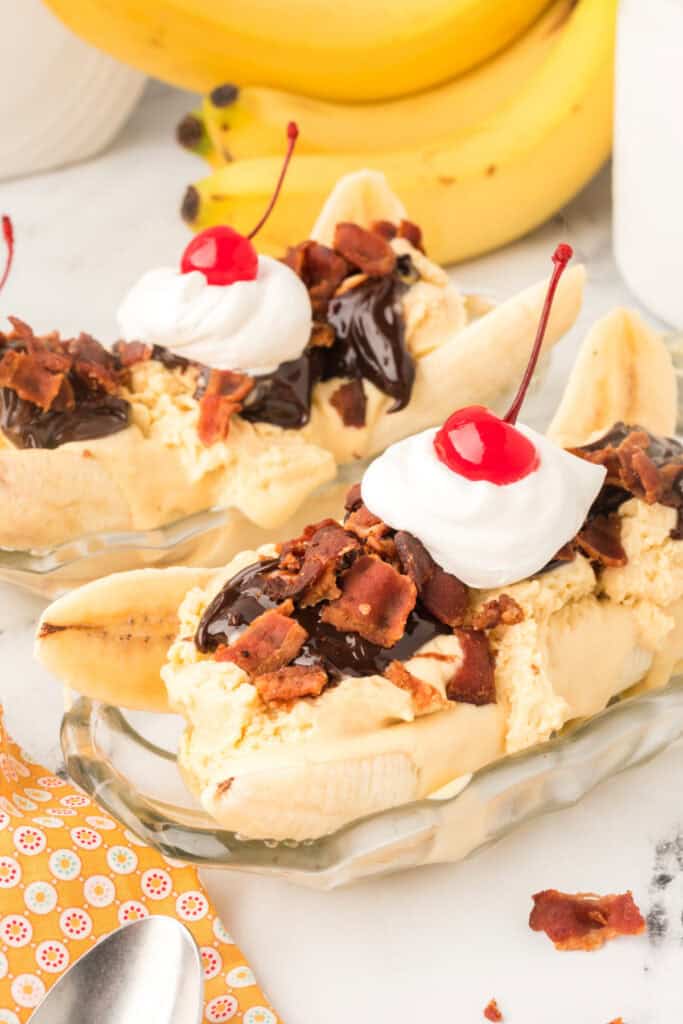 Elvis Banana Split topped with homemade peanut butter ice cream, whipped cream, crispy bacon, and a maraschino cherry.