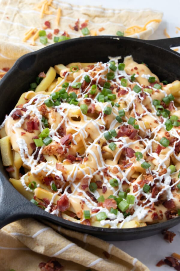 cheese fries with bacon in cast iron skillet