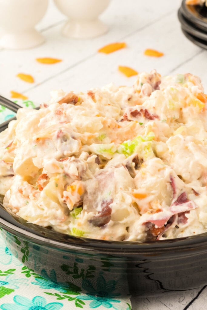 close up of bacon ranch potato salad in black bowl