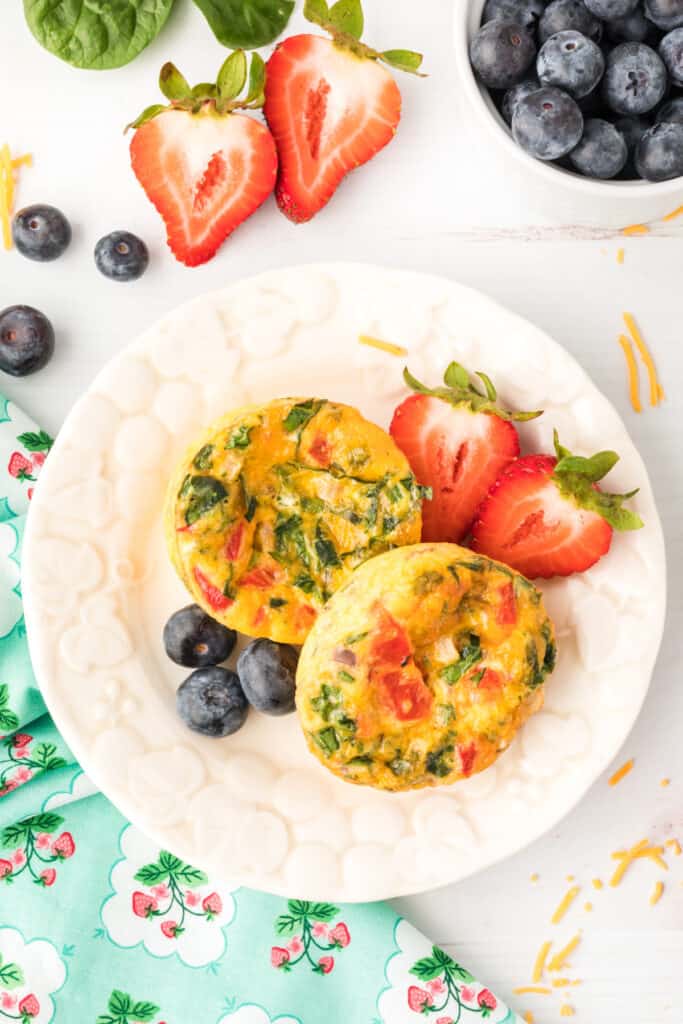 Breakfast Egg Muffins served on a plate with strawberries and blueberries