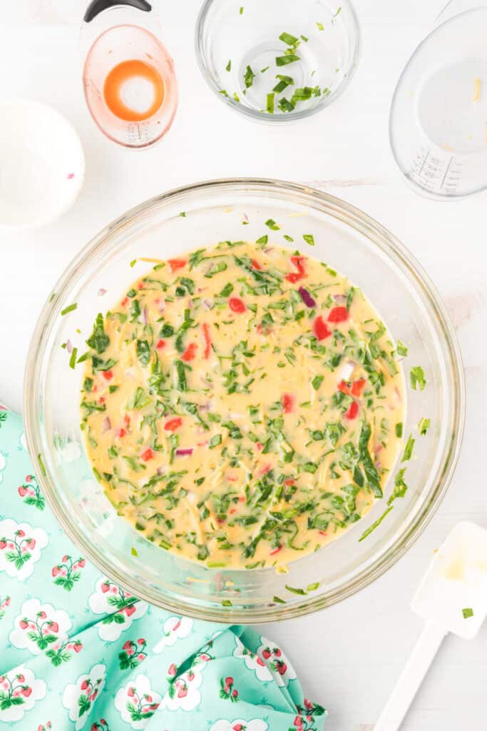 Mixed egg and vegetable filling for Breakfast Egg Muffins in a glass bowl