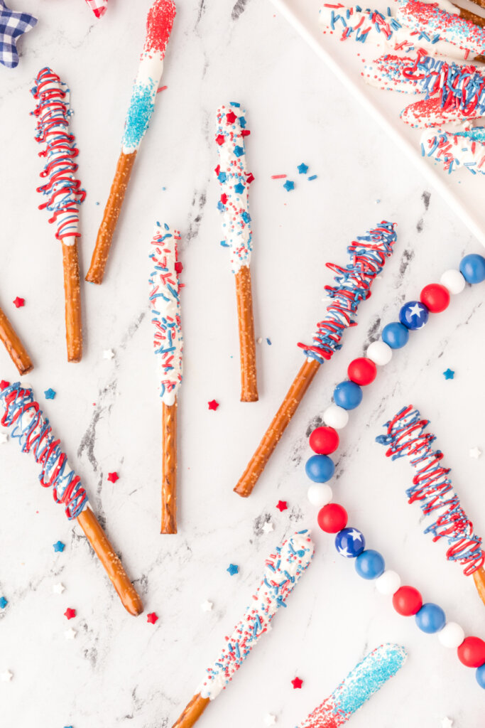 assorted chocolate covered pratzel rods laying in table