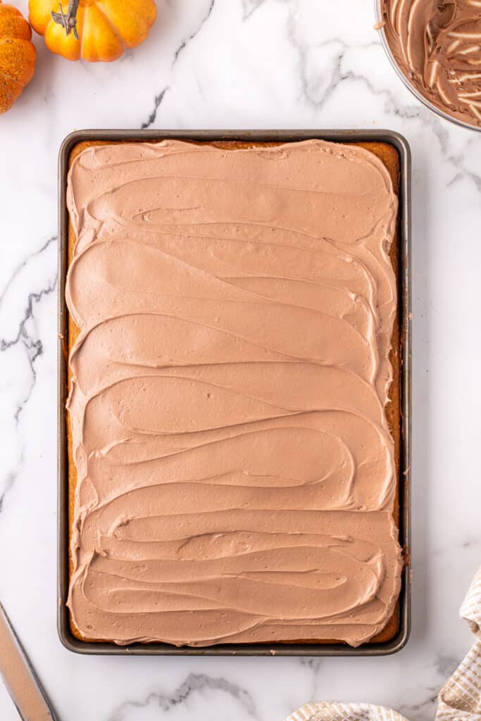Overhead view of a full pan of pumpkin bars freshly frosted with smooth Nutella buttercream.