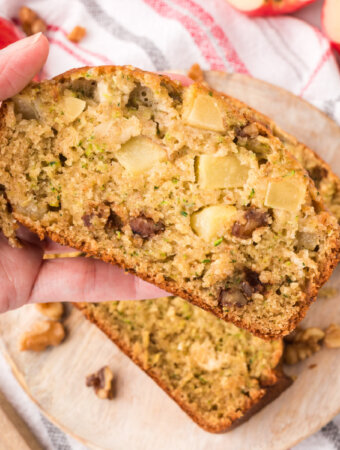 hand holding a slice of apple zucchini bread