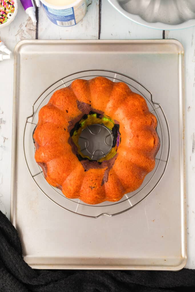 Halloween Bundt Cake inverted onto a wire rack over a baking sheet after baking.