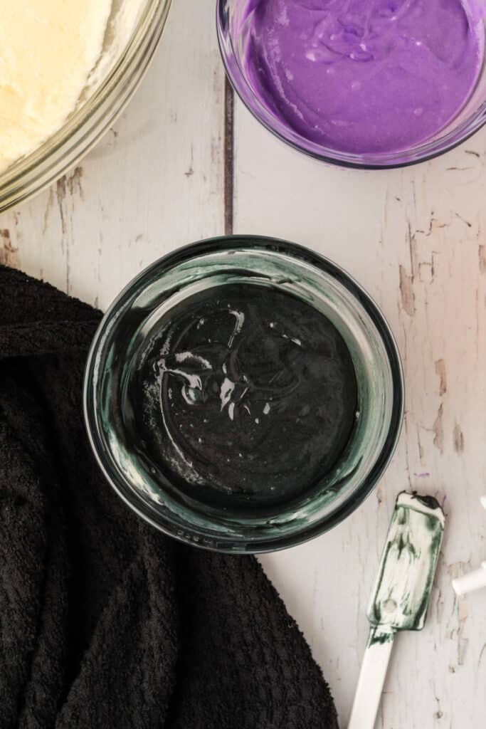 Bowl of black cake batter prepared for layering into Halloween Bundt Cake.