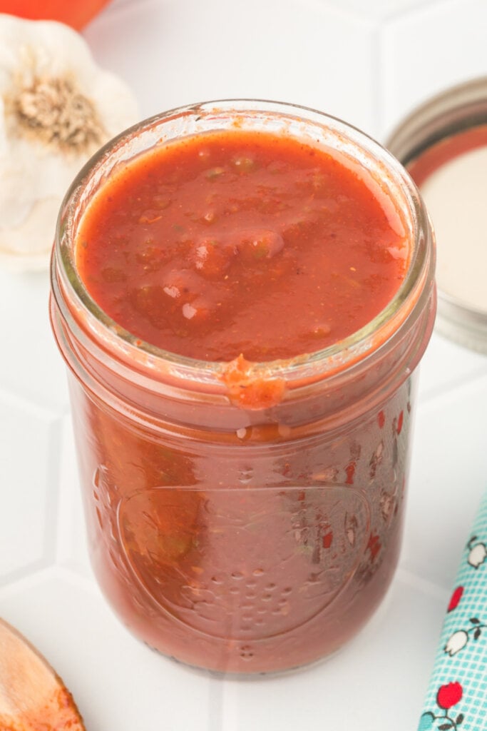 closeup of jar filled with homemade enchilada sauce