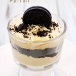 Pumpkin and Oreo Black Magic Parfait in a cup with an OREO cookie on top.