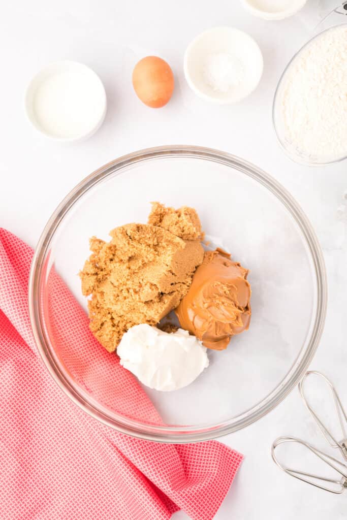 brown sugar, cookie butter, and shortening in a glass mixing bowl for Biscoff Butter Cookies