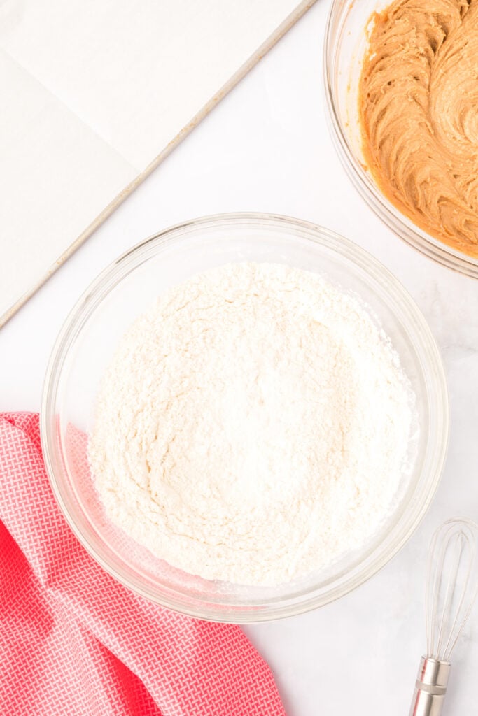 dry ingredients including flour and baking soda in a glass bowl for Biscoff Butter Cookies