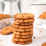 square image of biscoff butter cookies stacked on white surface