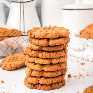 square image of biscoff butter cookies stacked on white surface
