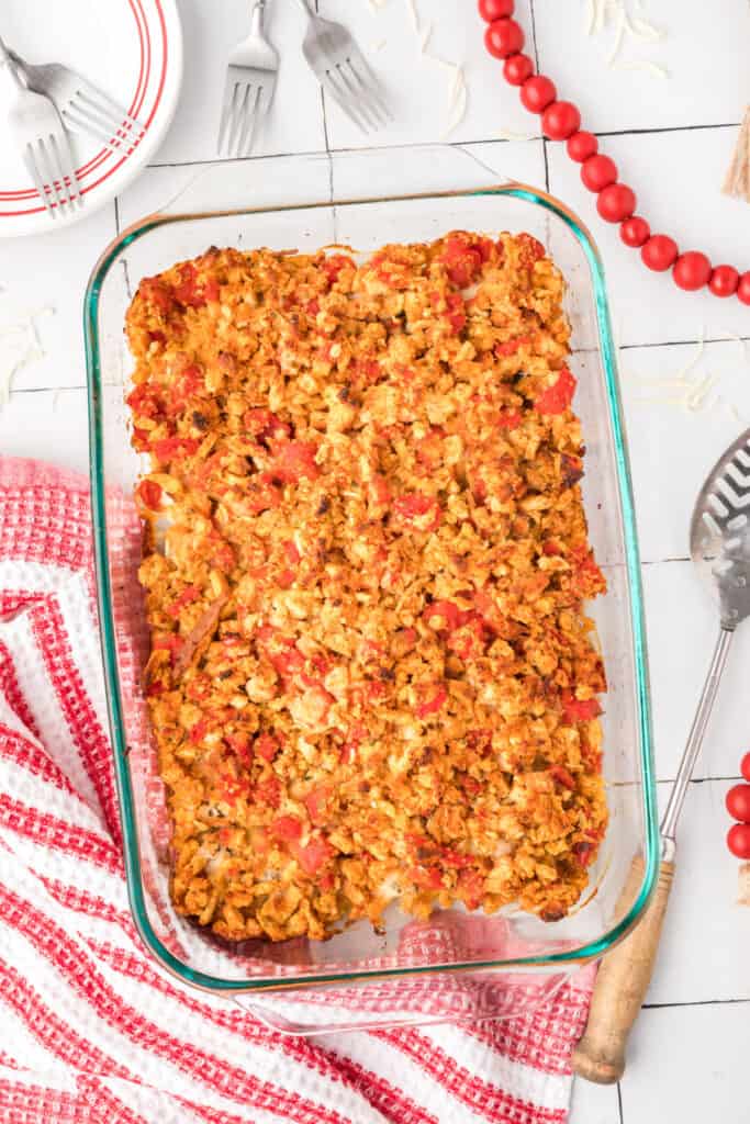 Baked Chicken Bruschetta Bake in a glass casserole dish with a golden stuffing topping and visible tomatoes.