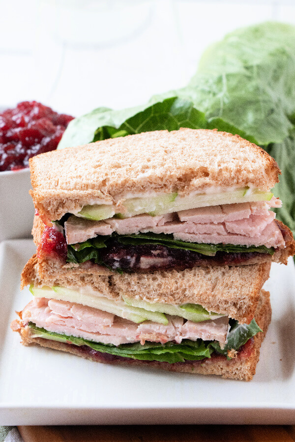 sandwich halves stacked on top of each other on plate