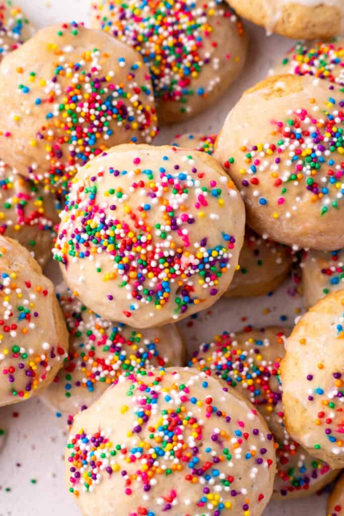 Overhead close-up of glazed and sprinkled Italian Ricotta Cookies grouped together