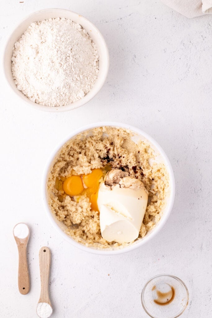 Eggs, ricotta cheese, and vanilla added to the creamed butter and sugar