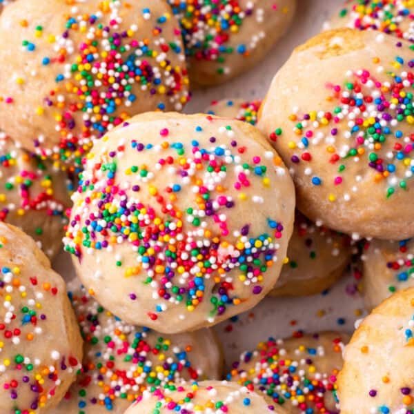 Square crop of glazed Italian Ricotta Cookies with colorful sprinkles