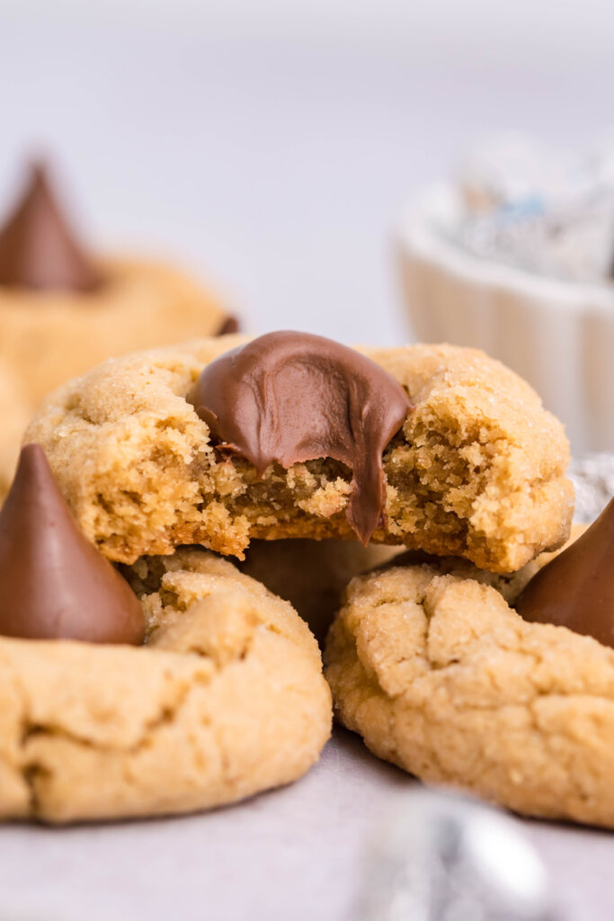 a peanut butter blossoms cookie bitten to see the inside texture