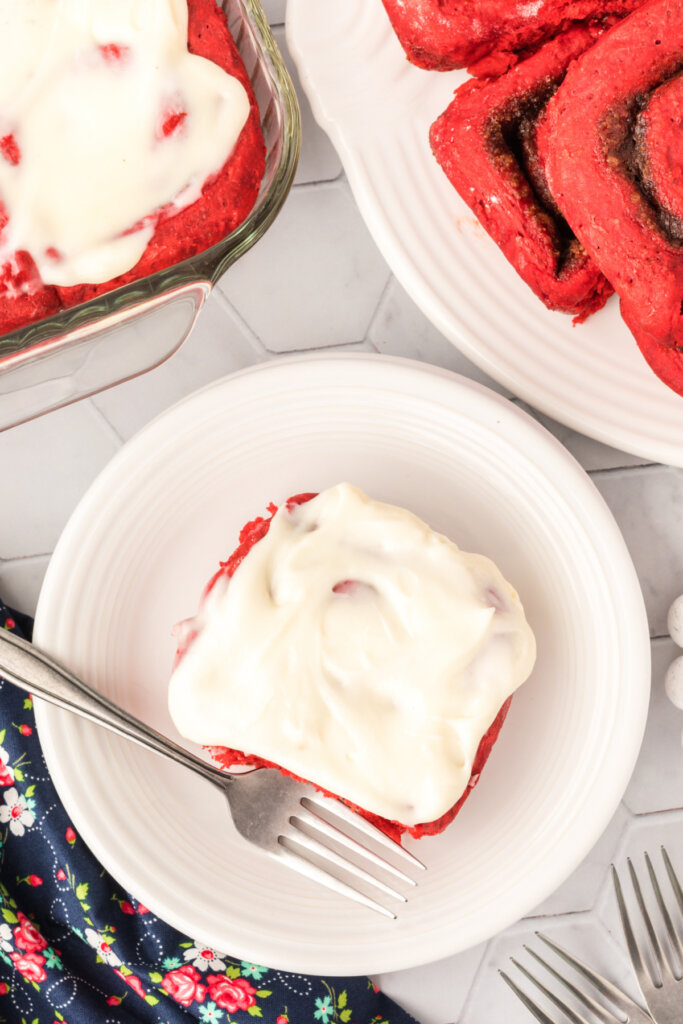 looking down onto a red velvet cinnamon roll on plate