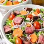 Steak and Blue Cheese Salad in a white bowl.