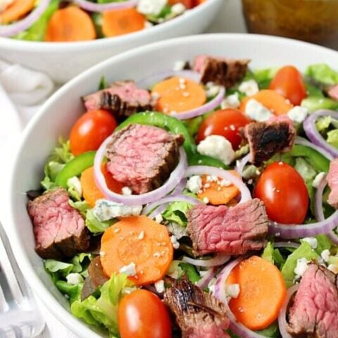 Steak and Blue Cheese Salad in a white bowl.
