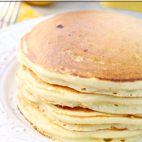 Lemon Berry Pancakes stacked on a plate.