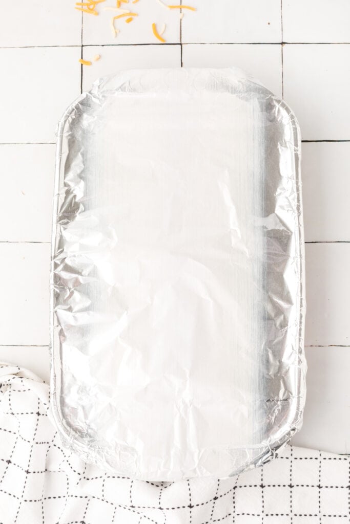 glass baking dish covered tightly with aluminum foil before baking